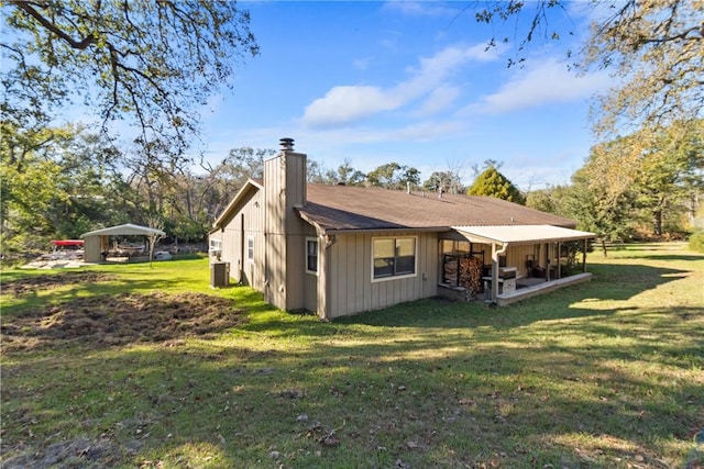 10072 Riley Green Rd, Franklin, TX 77856 - rear view of house with a chimney and a lawn