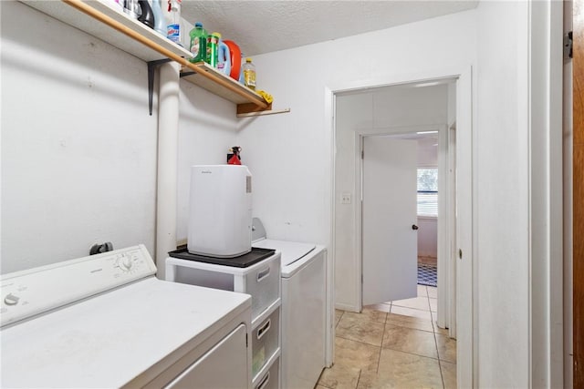 10072 Riley Green Rd, Franklin, TX 77856 - washroom with washer and clothes dryer and light tile patterned floors