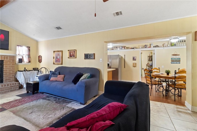10072 Riley Green Rd, Franklin, TX 77856 - living room featuring light tile patterned floors, a fireplace, and lofted ceiling