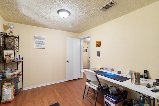 10072 Riley Green Rd, Franklin, TX 77856 - home office with wood finished floors and a textured ceiling