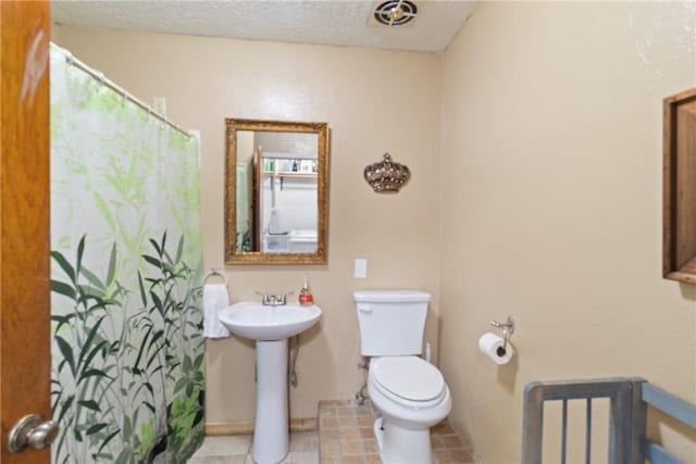 10072 Riley Green Rd, Franklin, TX 77856 - bathroom featuring a shower with shower curtain, tile patterned floors, and a textured ceiling