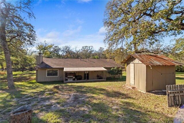 10072 Riley Green Rd, Franklin, TX 77856 - rear view of house featuring a chimney, a yard, and a shed