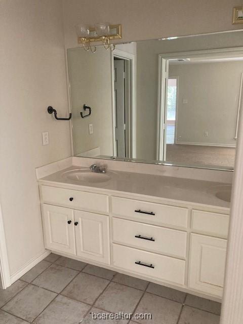 bathroom with tile patterned floors, vanity, and an inviting chandelier