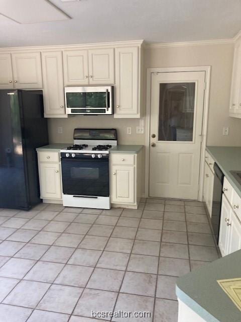 kitchen featuring black fridge, ornamental molding, dishwashing machine, white range with gas cooktop, and light tile patterned floors