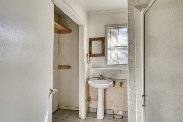 bathroom with an enclosed shower, crown molding, and tile patterned floors