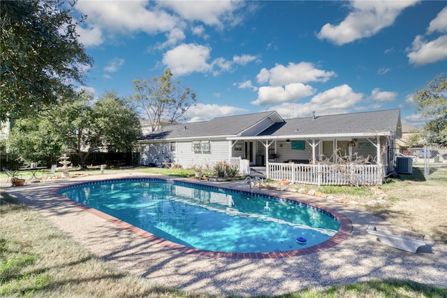 view of swimming pool featuring central air condition unit and a patio area