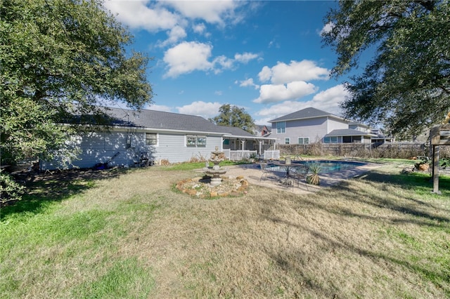 view of yard with a fenced in pool