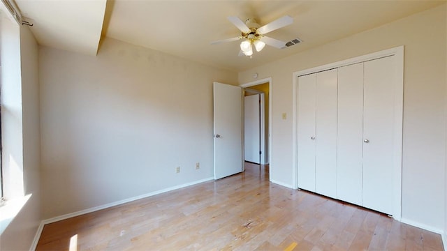 unfurnished bedroom with a closet, ceiling fan, and light hardwood / wood-style flooring