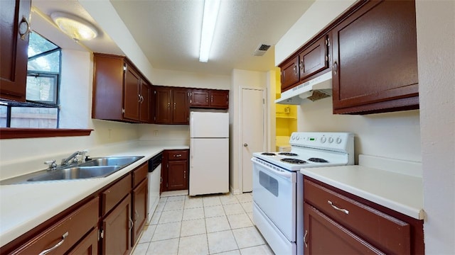 kitchen with sink, white appliances, a textured ceiling, and light tile patterned flooring