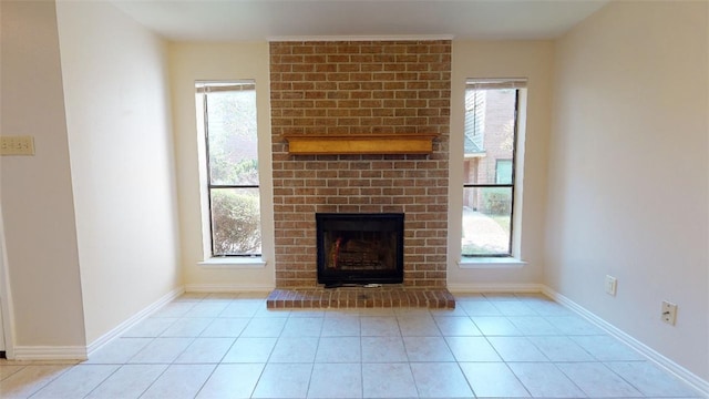 unfurnished living room with a healthy amount of sunlight, a fireplace, and light tile patterned floors