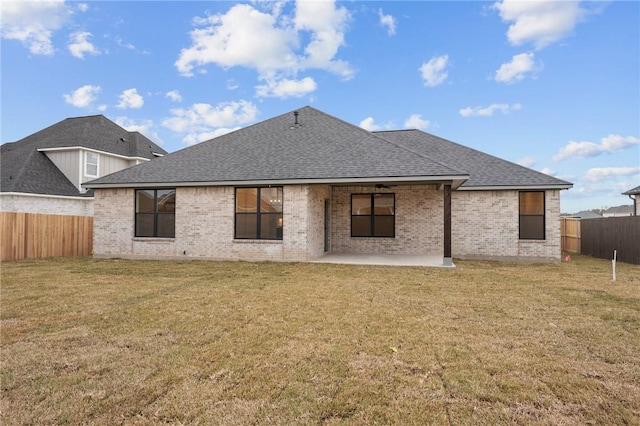 rear view of property with a lawn and a patio