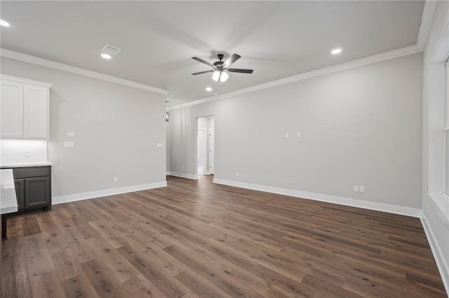 unfurnished living room with ceiling fan, dark hardwood / wood-style floors, and ornamental molding