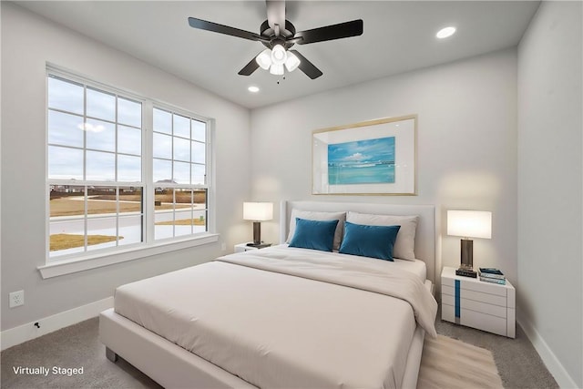 bedroom with ceiling fan and light colored carpet