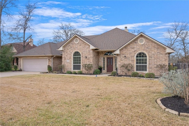 view of front facade with a front yard and a garage