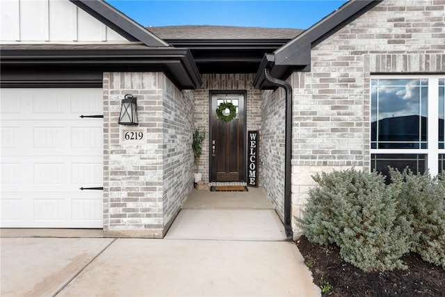 doorway to property with a garage