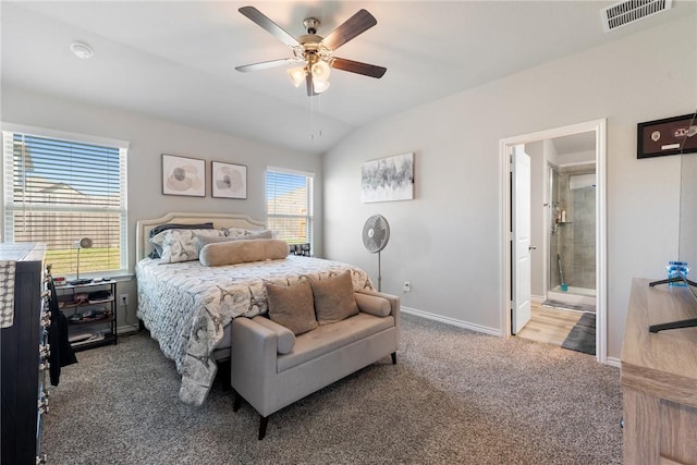 bedroom featuring ceiling fan, ensuite bathroom, lofted ceiling, and carpet flooring