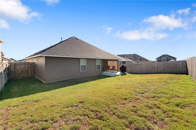 back of property with a patio area and a lawn