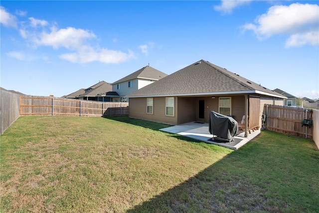 rear view of property with a lawn and a patio area