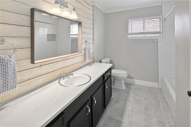 full bath featuring wooden walls, baseboards, toilet, ornamental molding, and vanity