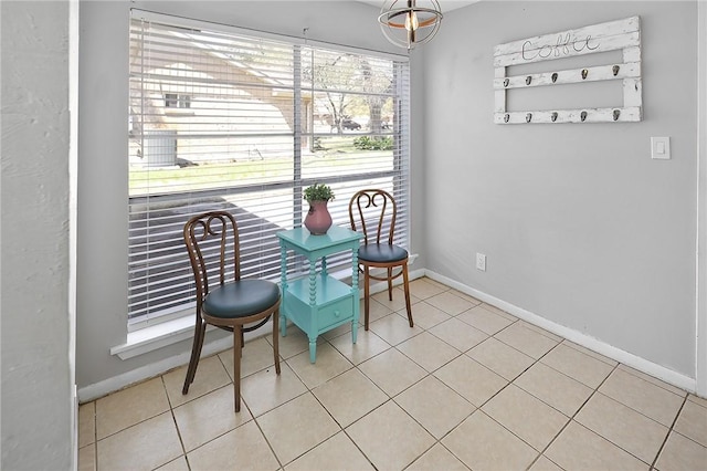 dining space featuring tile patterned floors and baseboards