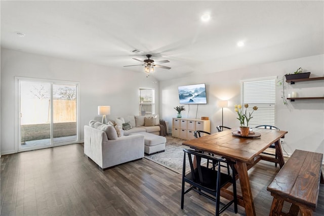 living room featuring ceiling fan and dark hardwood / wood-style flooring