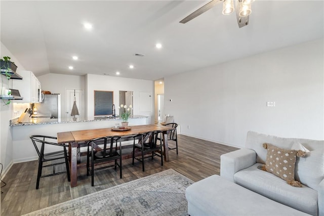 dining area with lofted ceiling, dark hardwood / wood-style floors, and ceiling fan