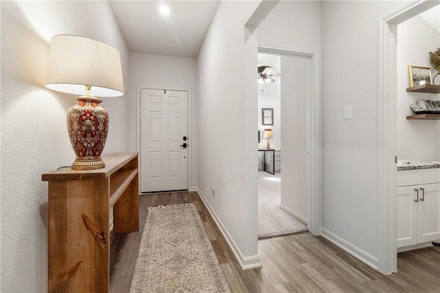 hallway with light hardwood / wood-style flooring