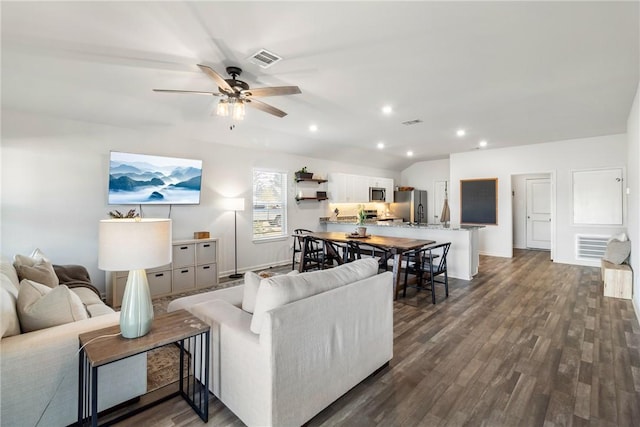 living room featuring lofted ceiling, dark hardwood / wood-style flooring, and ceiling fan