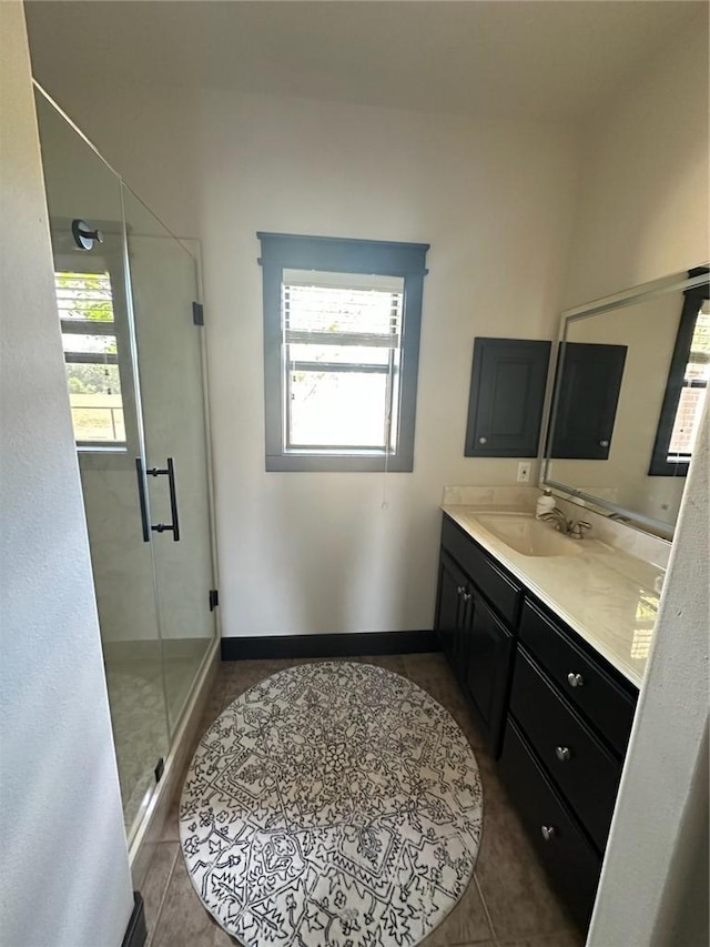 bathroom featuring vanity, tile patterned floors, walk in shower, and a healthy amount of sunlight