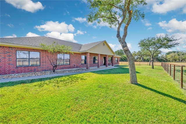 rear view of property with a yard