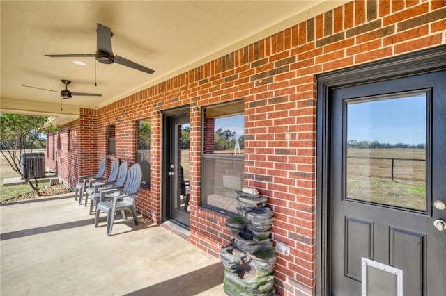 view of exterior entry featuring central air condition unit and ceiling fan