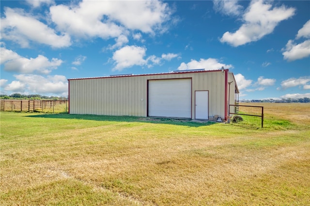 view of outbuilding featuring a yard and a rural view