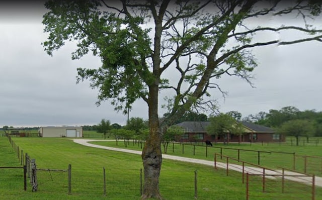 surrounding community featuring a lawn and a rural view