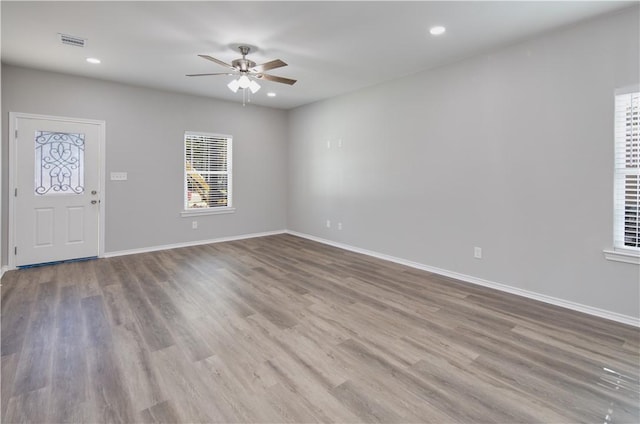 507 Brosig Ave, Navasota, TX 77868 - unfurnished living room featuring a ceiling fan, wood finished floors, and recessed lighting