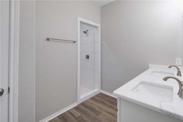 507 Brosig Ave, Navasota, TX 77868 - full bathroom with a tile shower, wood finished floors, and double vanity