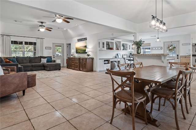 dining space with light tile patterned flooring, lofted ceiling, and a wealth of natural light