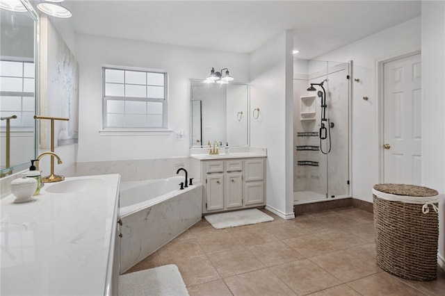 bathroom featuring tile patterned floors, independent shower and bath, and vanity