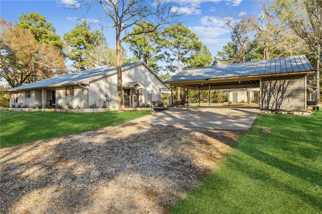 view of home's exterior with a lawn and a carport