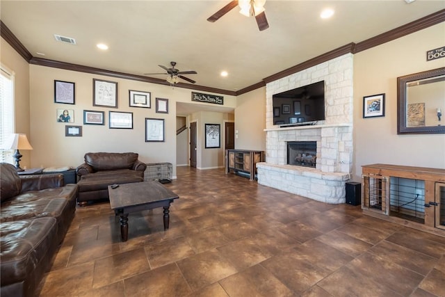 living room featuring visible vents, ceiling fan, ornamental molding, a stone fireplace, and recessed lighting