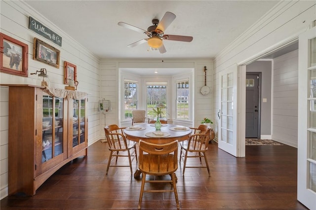 dining area with a ceiling fan, french doors, dark wood-style flooring, and ornamental molding