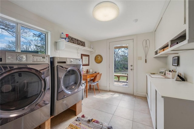 laundry room with light tile patterned floors, laundry area, baseboards, and separate washer and dryer