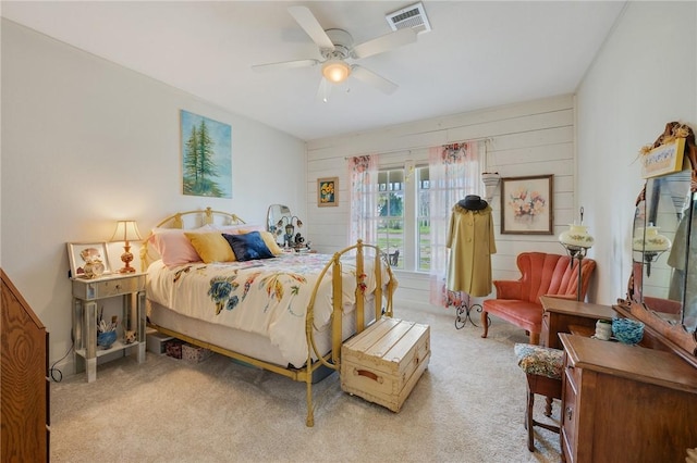 carpeted bedroom featuring a ceiling fan and visible vents