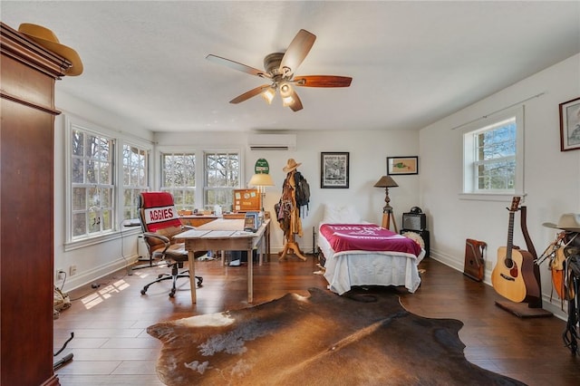 office featuring wood finished floors, baseboards, a wall mounted air conditioner, and ceiling fan