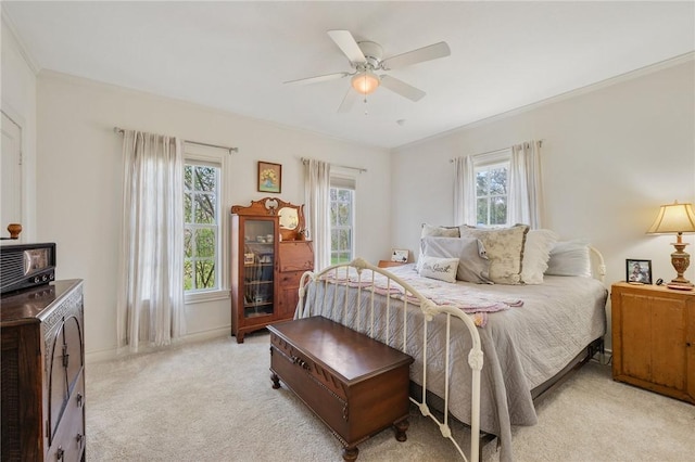 bedroom featuring a ceiling fan, baseboards, a wood stove, crown molding, and light colored carpet