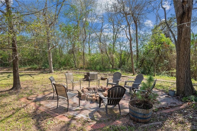 view of yard featuring a fire pit and a patio area