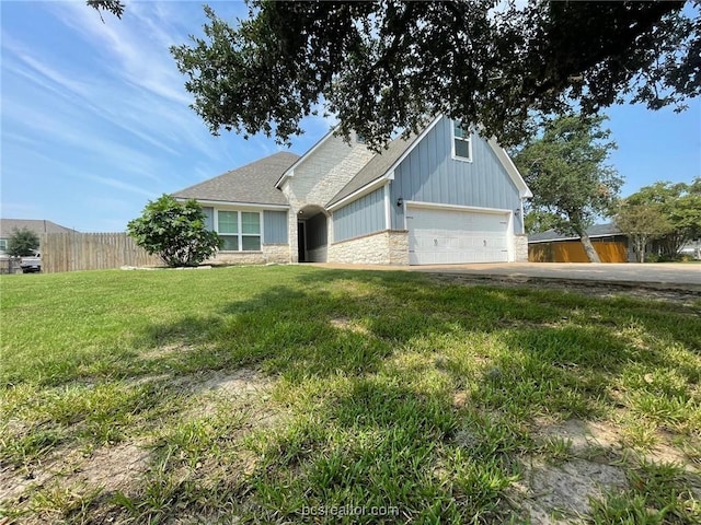 view of front of house featuring a garage and a front lawn