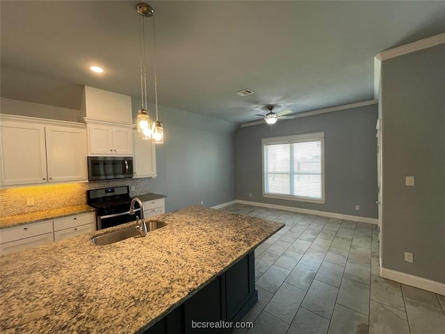 kitchen featuring sink, hanging light fixtures, stainless steel appliances, a center island with sink, and white cabinets