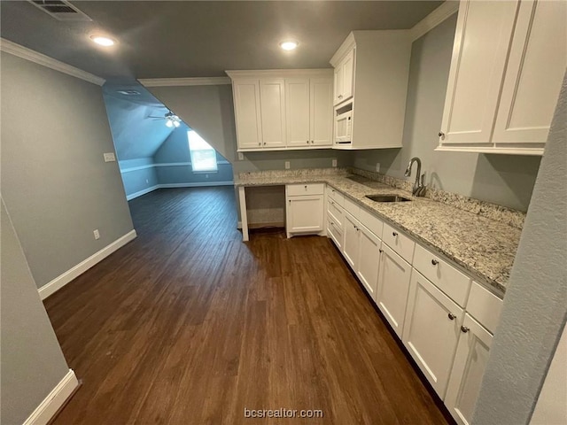 kitchen featuring light stone counters, crown molding, sink, dark hardwood / wood-style floors, and white cabinetry