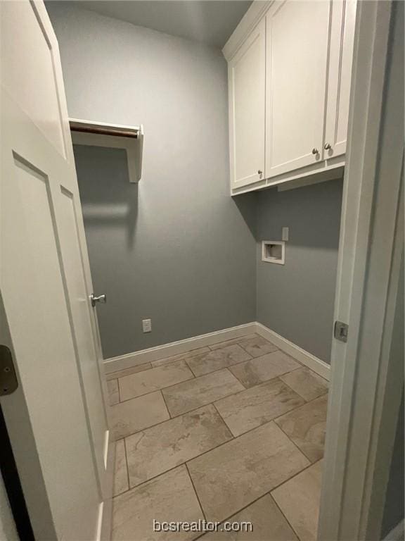 laundry room with washer hookup and cabinets