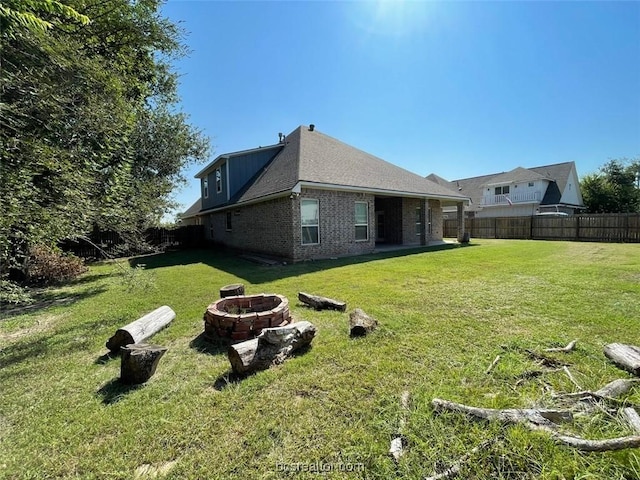 view of yard with an outdoor fire pit